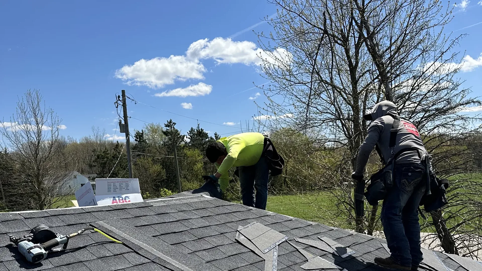 Platinum Roofing crew installing ridge cap shingles at the peak of a new asphalt roof