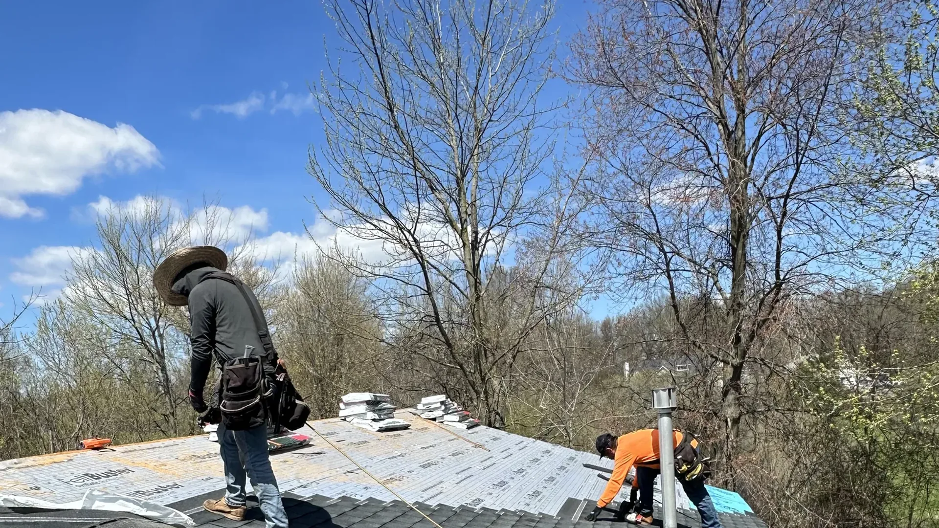 Platinum Roofing crew installing asphalt shingles over synthetic underlayment on a residential roof